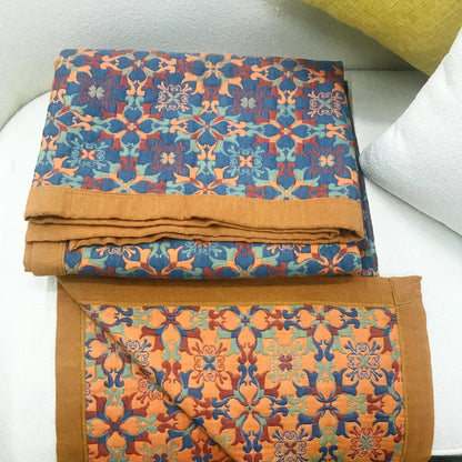 Colorful six-layer cotton quilt with a unique orange and blue pattern, ideal for modern bedroom decor.