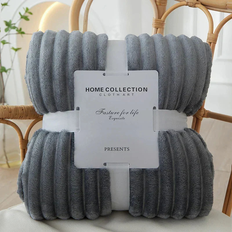 Plush flannel fleece blanket in wide stripes, adding comfort & style to home decor.