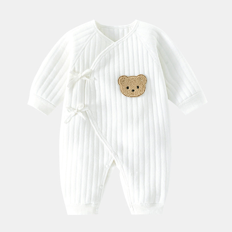 Happy baby wearing a cozy bear romper, crawling & playing. Soft infant clothing for spring/fall.