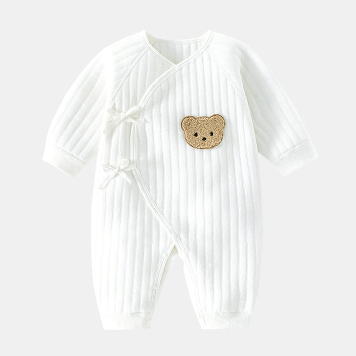 Happy baby wearing a cozy bear romper, crawling & playing. Soft infant clothing for spring/fall.