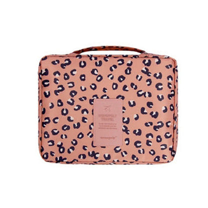 Women's waterproof makeup organizer, dark blue floral design, keeps cosmetics safe & organized for travel.
