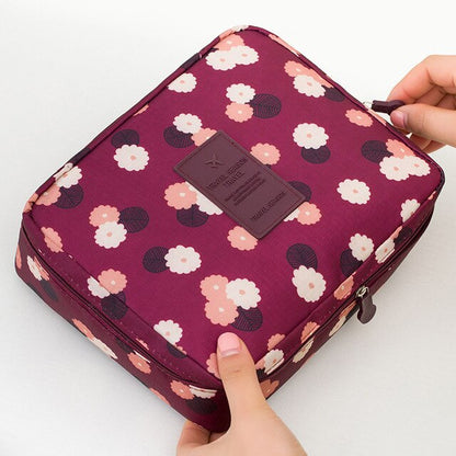 Portable dark blue floral waterproof cosmetic bag, perfect for travel, everyday use, and beauty storage.