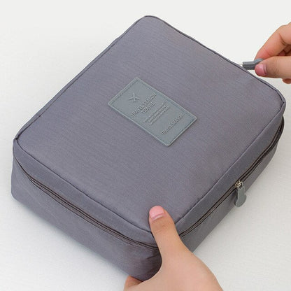 Compact dark blue floral waterproof makeup storage case, ideal for keeping toiletries organized on trips.