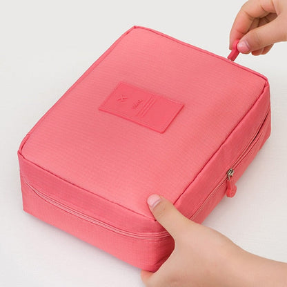 Elegant dark blue floral travel cosmetic case, waterproof and compact, includes a bonus mini pouch.