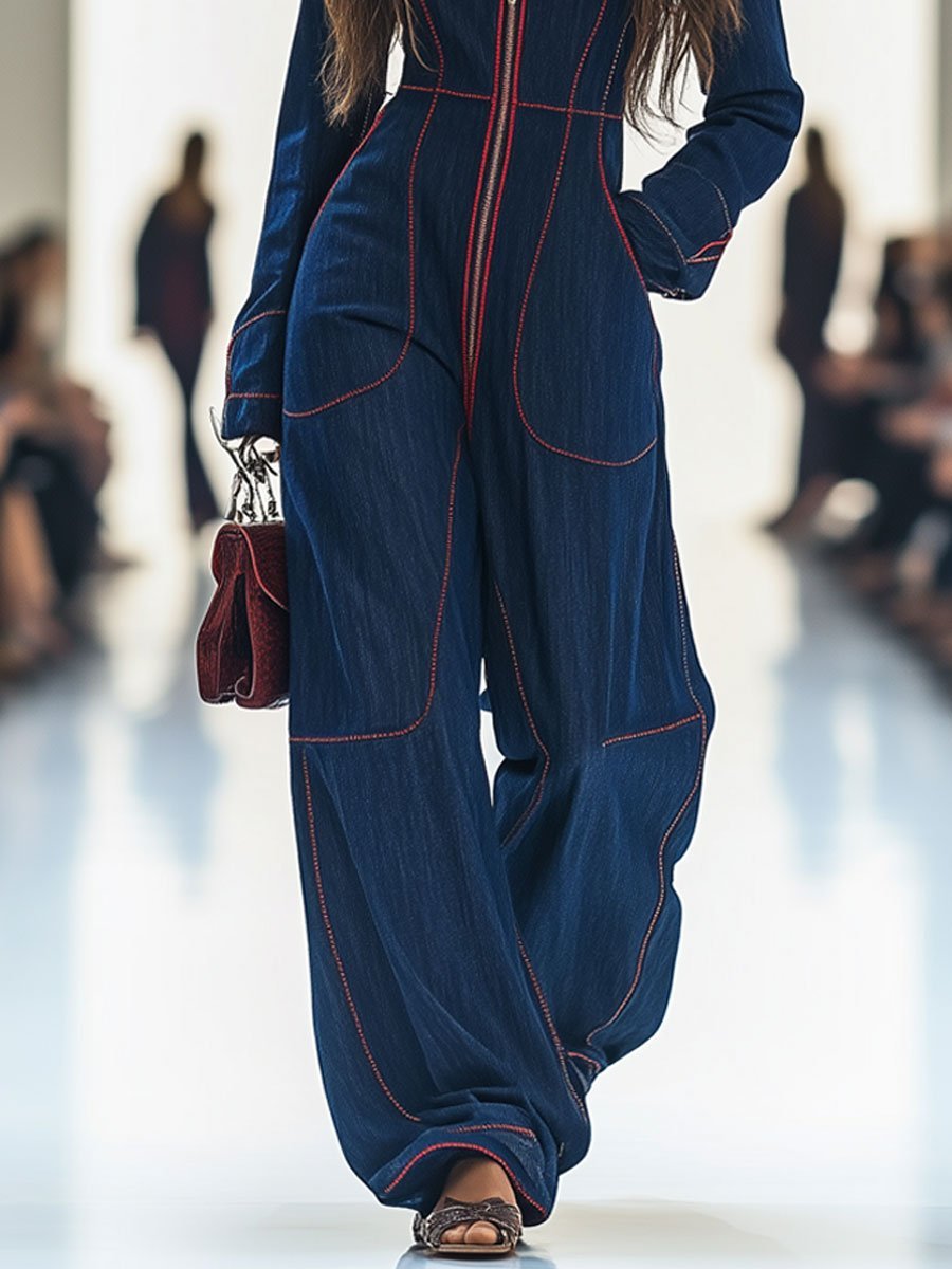 Close-up of the zip front on a dark blue women's wide leg jumpsuit, highlighting modern fashion details.