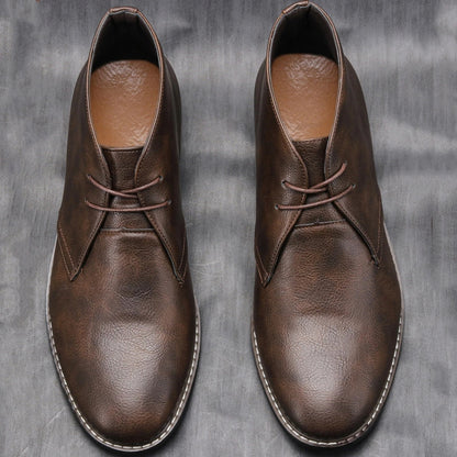 Men's dark brown leather ankle boots, essential casual footwear known for comfort & rugged appeal.