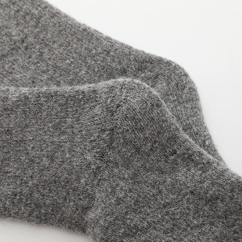 Pair of black cozy comfort socks, unisex, one size, designed for ultimate warmth & softness.