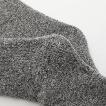 Pair of black cozy comfort socks, unisex, one size, designed for ultimate warmth & softness.