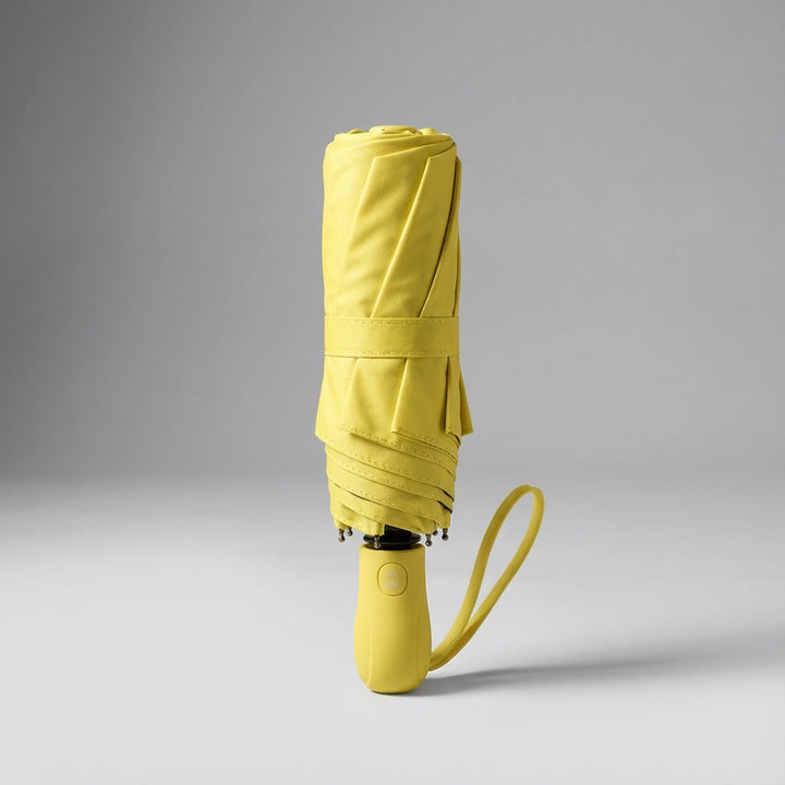 Compact dark green rain umbrella, lightweight & portable. Offers UV protection for all weather.