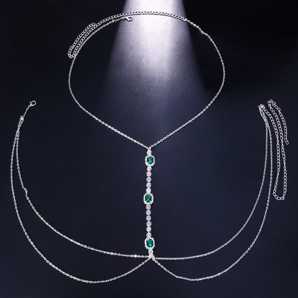 Elegant women's green crystal chest chain. Dazzling rhinestone body jewelry, a sparkling statement piece for any look.