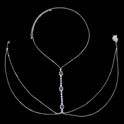 Sparkling women's green crystal chest chain. Festival-ready rhinestone body jewelry, a dazzling and elegant statement.