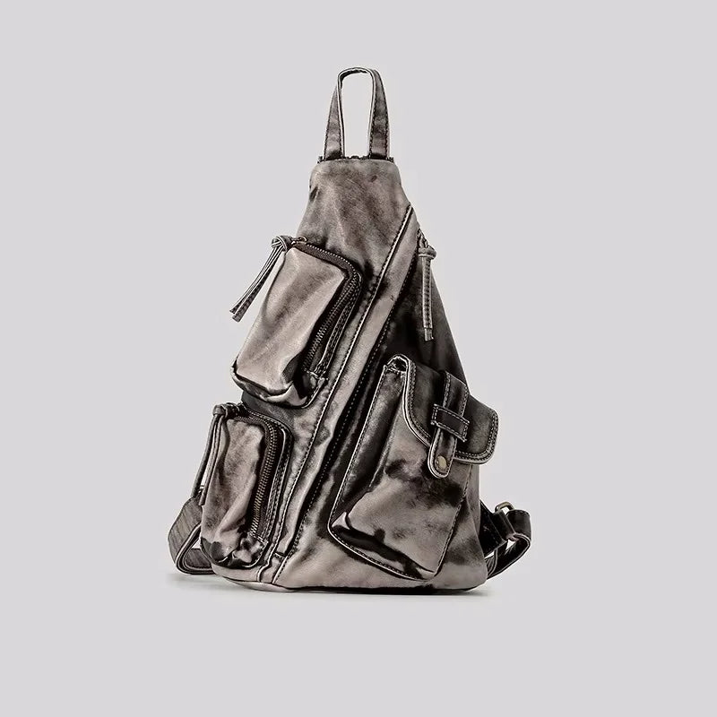 Distressed vintage women's convertible backpack, functions as sling, chest or travel bag.