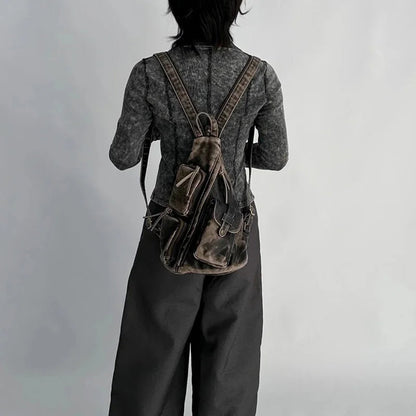 Fashionable women's convertible backpack; wear as a sling, chest, or travel bag with vintage look.