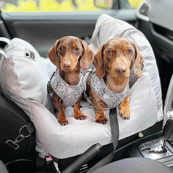 Comfortable dog booster car seat, washable pet bed, & non-slip base for safe vehicle travel.