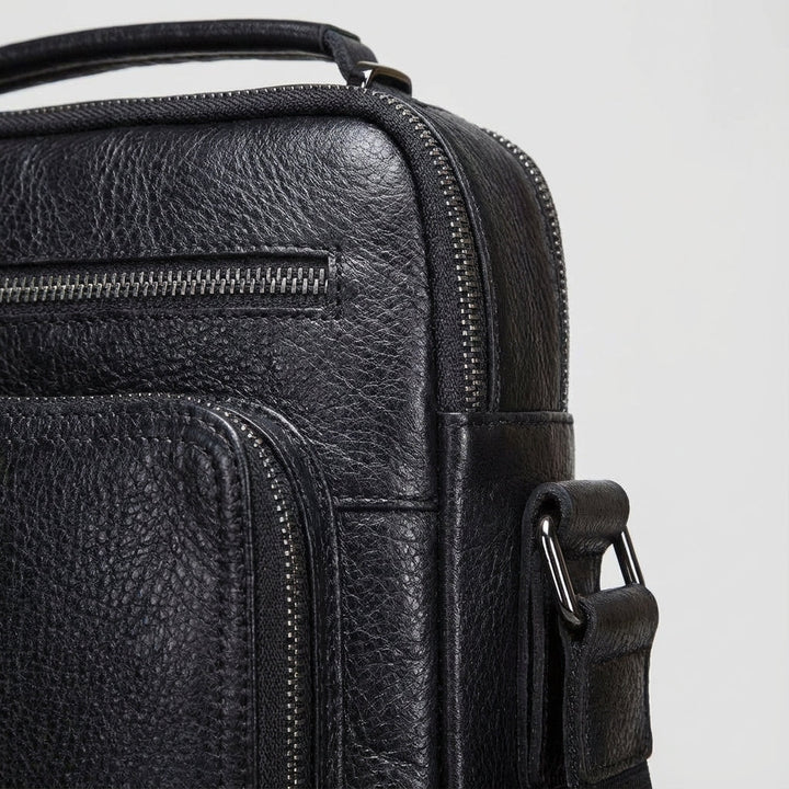 Stylish black leather messenger bag, a durable unisex crossbody for students, work, & daily carry.