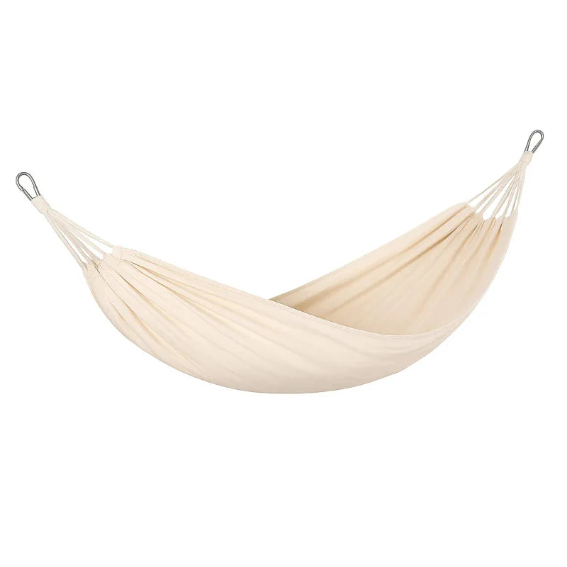 Portable camping gear: canvas hammock with spreader bars, designed for anti-rollover stability at beach or camp