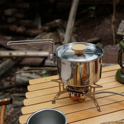 Durable stainless steel camping kettle for outdoor cooking, portable and lightweight for backpacking.