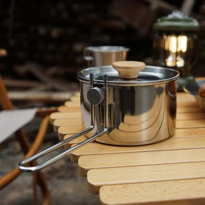 Stainless steel camping kettle, ideal for hot drinks and meals during outdoor adventures and camp kitchen use.