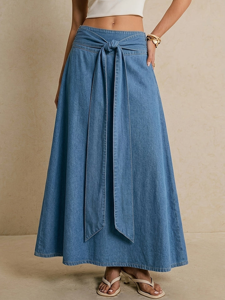 Effortless blue denim maxi skirt for women with a stylish tie waist, perfect for casual spring fashion.