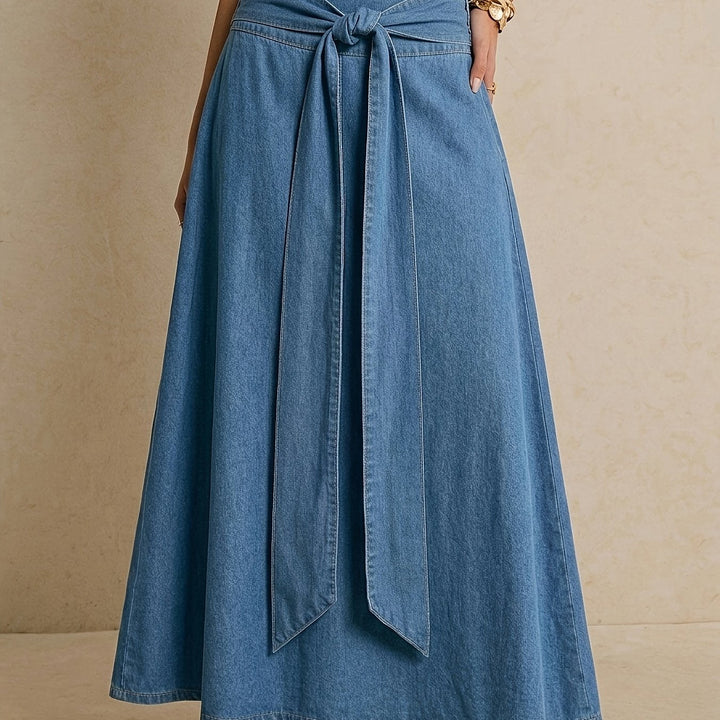 Stylish women's blue denim maxi skirt with an elegant tie waist, great for effortless spring/summer style.