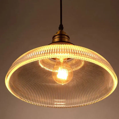 Warm light amber glass pendant lamp, a decorative ceiling fixture creating cozy home lighting ambiance.