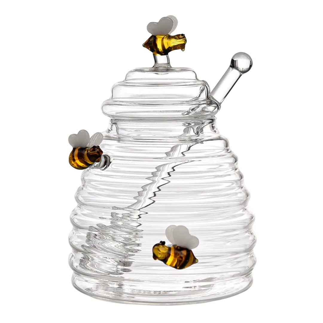 Functional beehive glass honey jar with built-in dipper for easy serving.