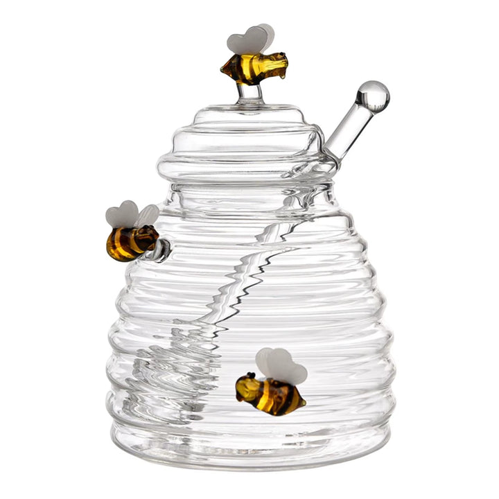 Functional beehive glass honey jar with built-in dipper for easy serving.