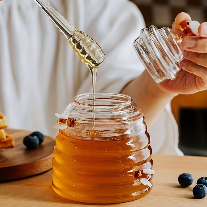 Stylish beehive design glass honey jar with lid & dipper for kitchen use.