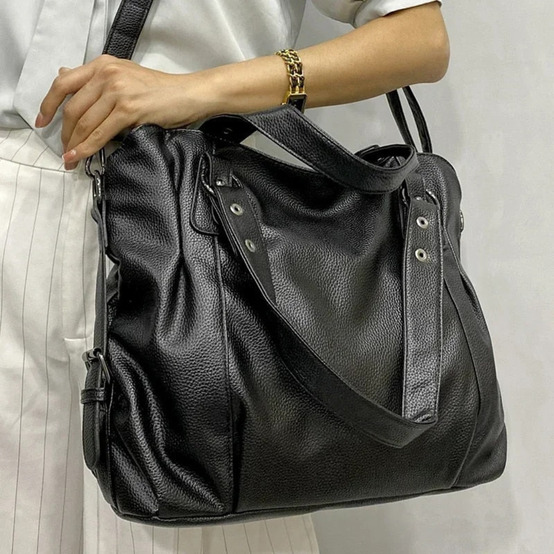 Spacious black luxury leather shoulder bag for women, EliteCarry, with organized compartments and versatile design.