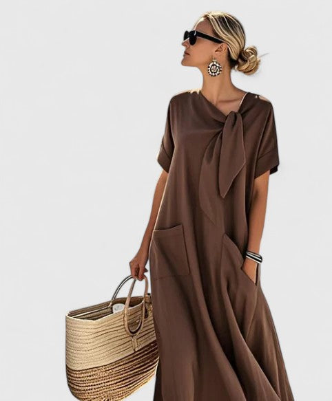Elegant beige women's summer midi dress, flowing fabric, ideal for casual chic day to evening style or vacation.