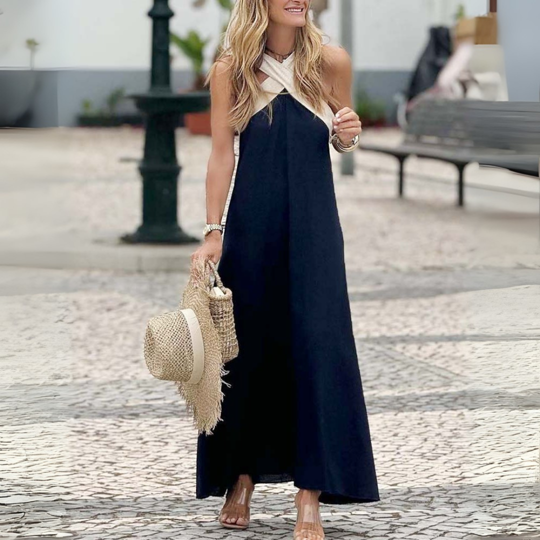 Stylish black sleeveless cross-neck summer dress, a chic women's A-line fashion choice for vacation.