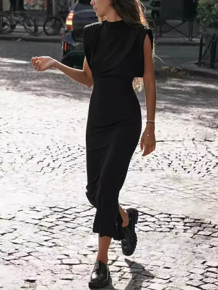 Versatile black midi dress, a women's fashion essential. Features a flattering silhouette, ideal for office to evening.