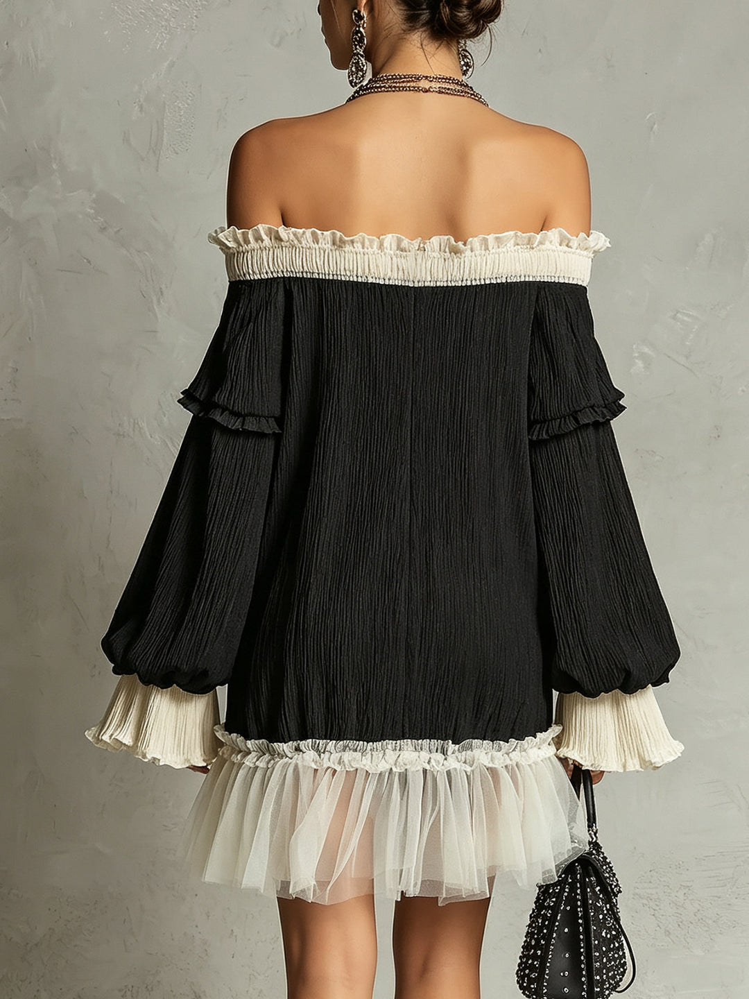 Stylish black ruffle mini dress featuring an off-shoulder neckline & lace trim. Perfect for a chic evening or party.