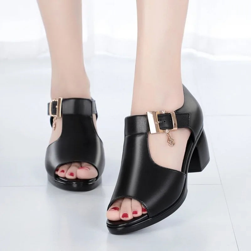 Front view of women's black block heels, highlighting the open-toe design and elegant buckle.