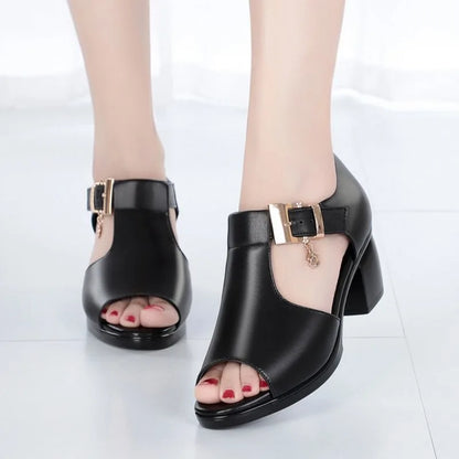Front view of women's black block heels, highlighting the open-toe design and elegant buckle.
