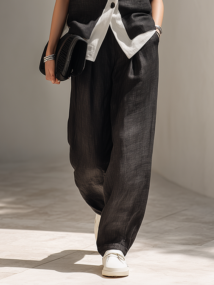 Chic black two-piece outfit with a tailored vest and comfortable wide-leg pants, suitable for evening or office.