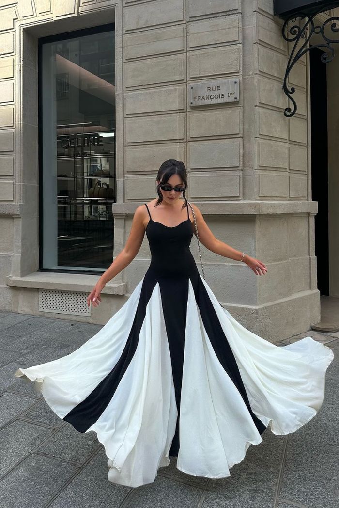 Striking black & white contrast maxi wedding guest dress, an elegant formal evening gown design.