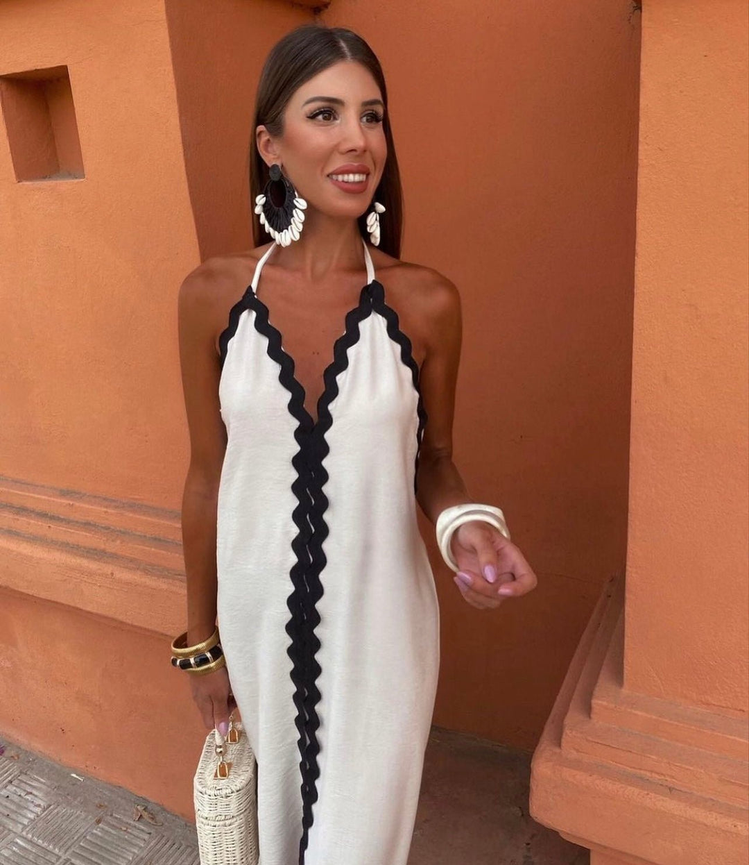 Women's formal black and white contrast maxi dress, V-neck, sleeveless. Stylish summer wedding guest attire.