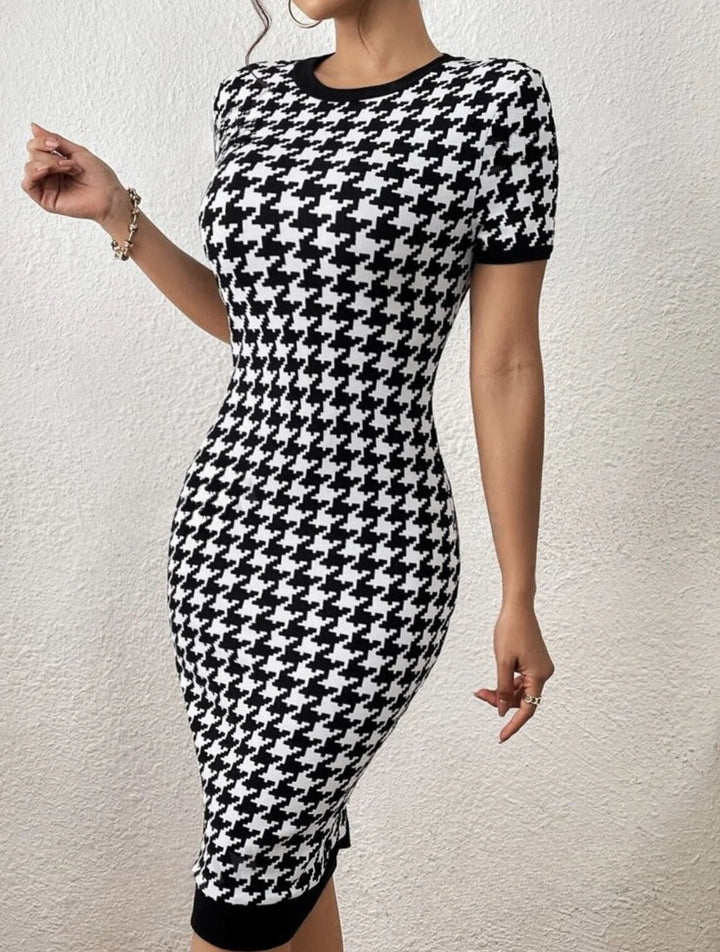 Sophisticated long sleeve houndstooth knit midi dress. Black & white pattern for a versatile, classic look.