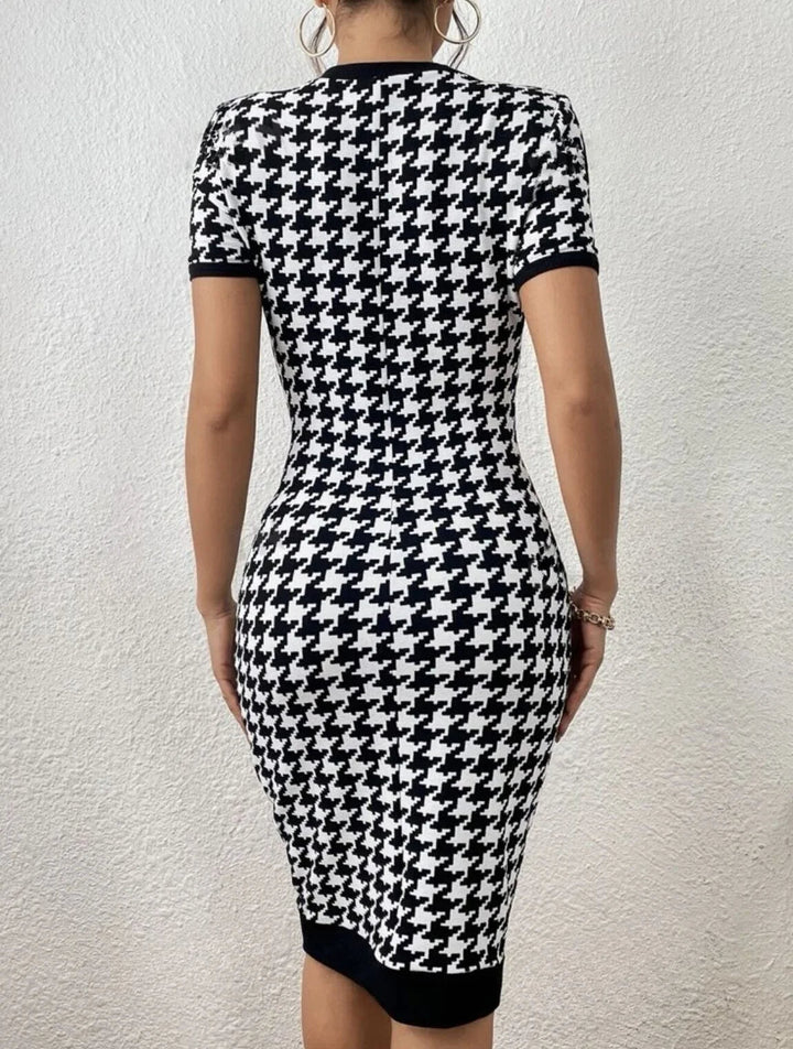 Elegant women's houndstooth knit midi dress with long sleeves. Chic black & white pattern for timeless style.