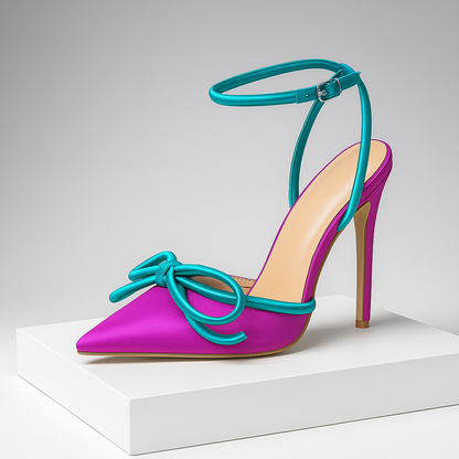 Elegant black women's stiletto heels with delicate bow detail, pointed toe, and secure ankle strap for formal wear.