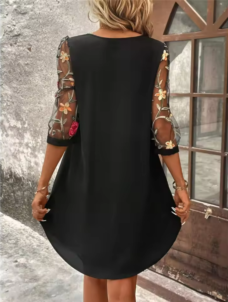 Stylish black floral V-neck dress for women, with sheer sleeves & comfortable, flattering fit. Versatile party wear.