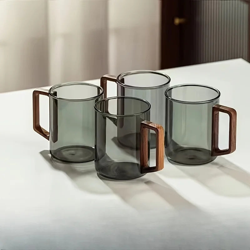 Elegant borosilicate glass coffee mug with a sleek walnut wood handle. Modern kitchen accessory.