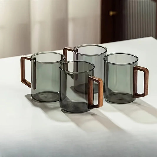Elegant borosilicate glass coffee mug with a sleek walnut wood handle. Modern kitchen accessory.