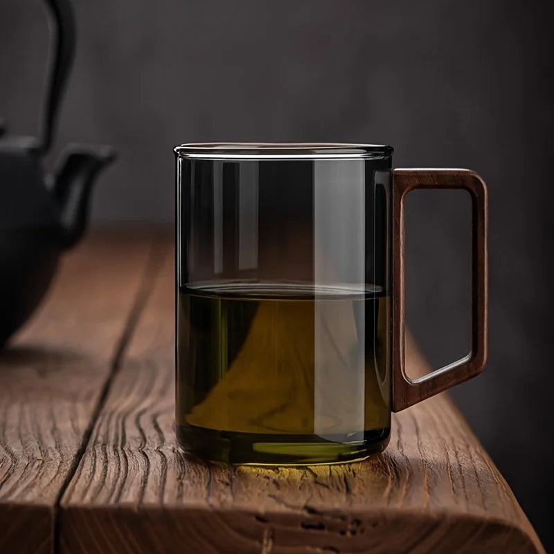 Clear glass coffee mug featuring a distinct walnut wood handle for a comfortable, stylish grip.