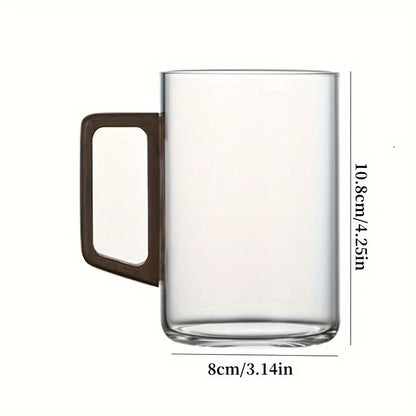 Modern borosilicate glass tea cup or coffee mug with a unique ergonomic walnut wood handle.