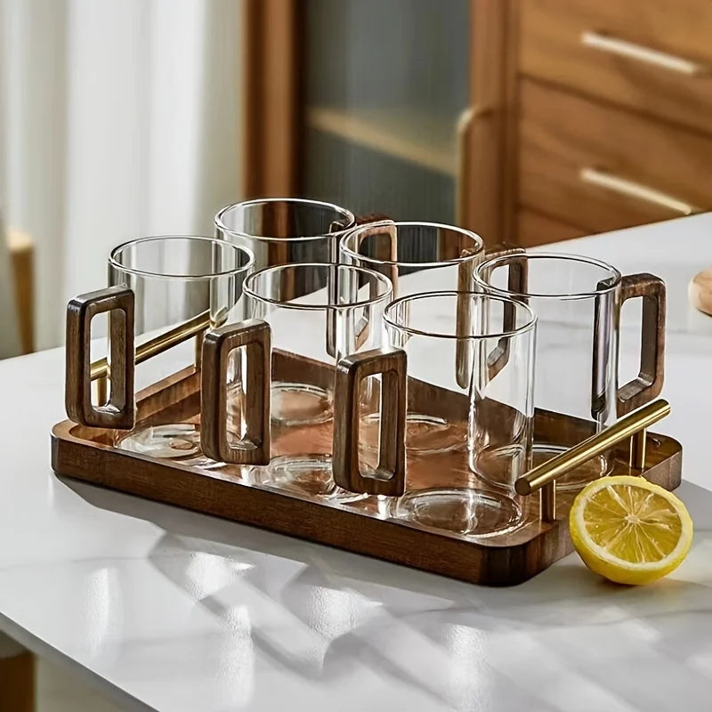 Stylish modern drinkware: a clear glass coffee mug with a sophisticated walnut wood handle.