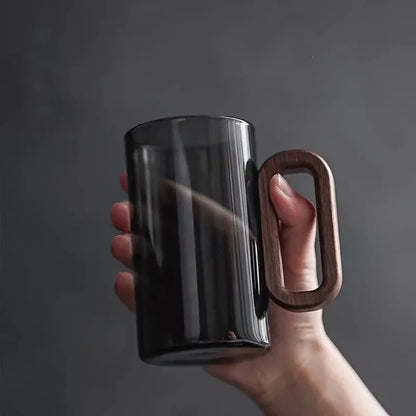 Unisex elegant glass coffee mug with a warm walnut handle. High-quality borosilicate glass drinkware.