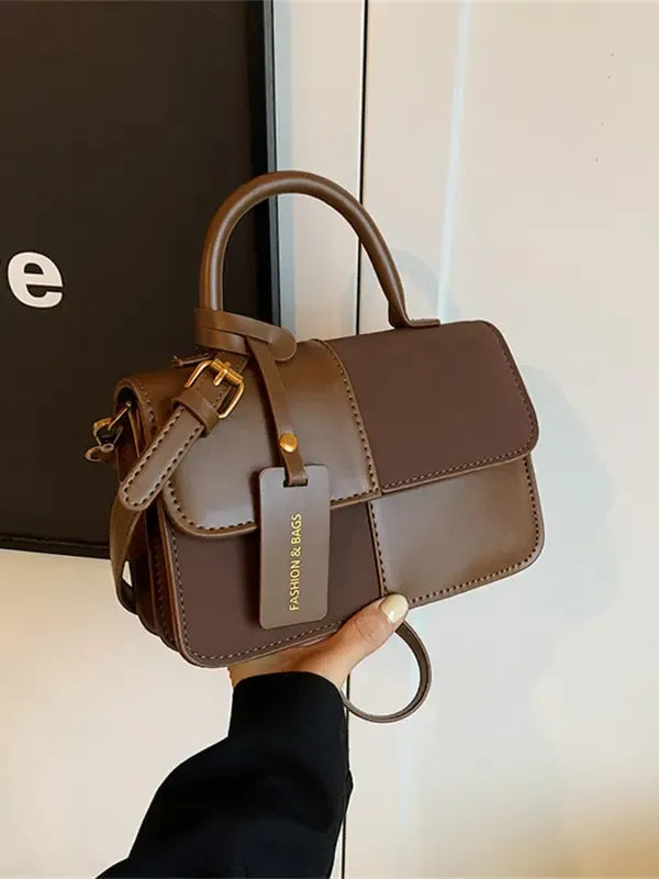 Elegant brown structured top handle bag for women, a versatile and stylish accessory for any occasion.