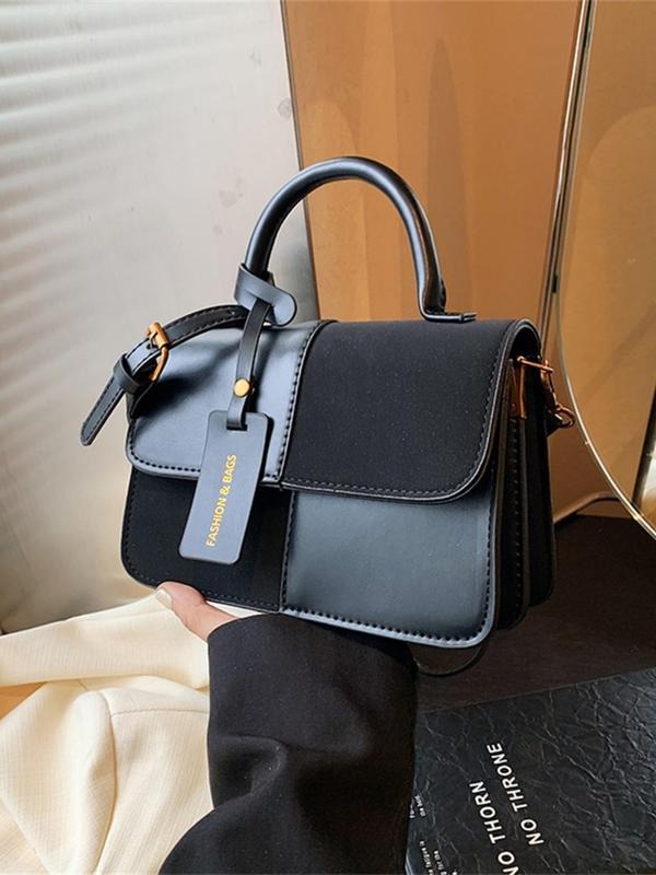 Chic black structured top handle bag, a versatile women's accessory perfect for both day and night.